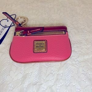 Dooney and Bourke coin purse. Pink pebble leather, brown leather trim. 5”x3.5”